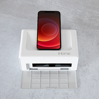 iHOME<sup>&reg;</sup> Photo Printer Dock - 2-in-1  Smartphone Photo Printer and Charging Station – Features easy to use controls to charge and print directly from your iPhone or Android device. Bluetooth technology, vibrant 4in x 6in photo prints are created in under 50 seconds. Real ink and glossy paper that works with iHome print app for editing, printing, and sharing of photos. Includes Ihc 46 Cartridge, 10 Photo Sheets, Power Adapter and Cord. 